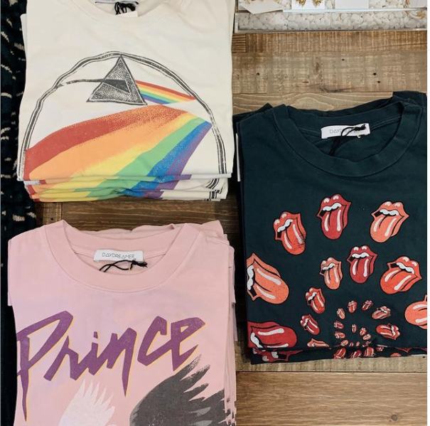 three vintage tees pictured on a wood table