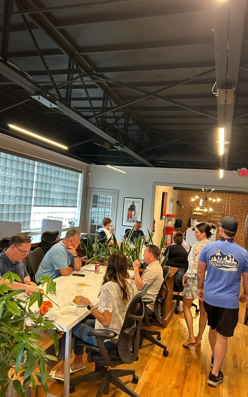 A photo of fireworks coworking space in marietta ga with people talking and discussing