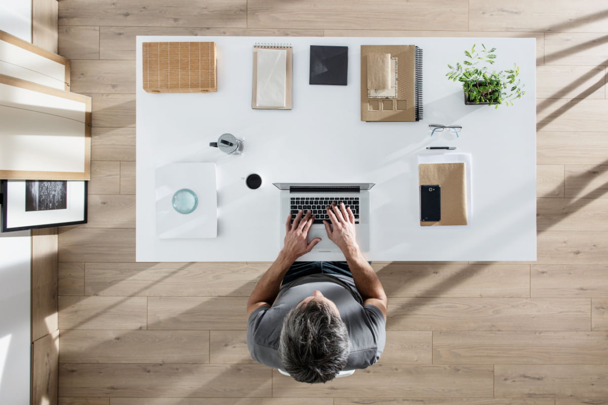 Organized Desk With Green Plant Small Things You Should be Doing to Increase Positivity in the Workplace