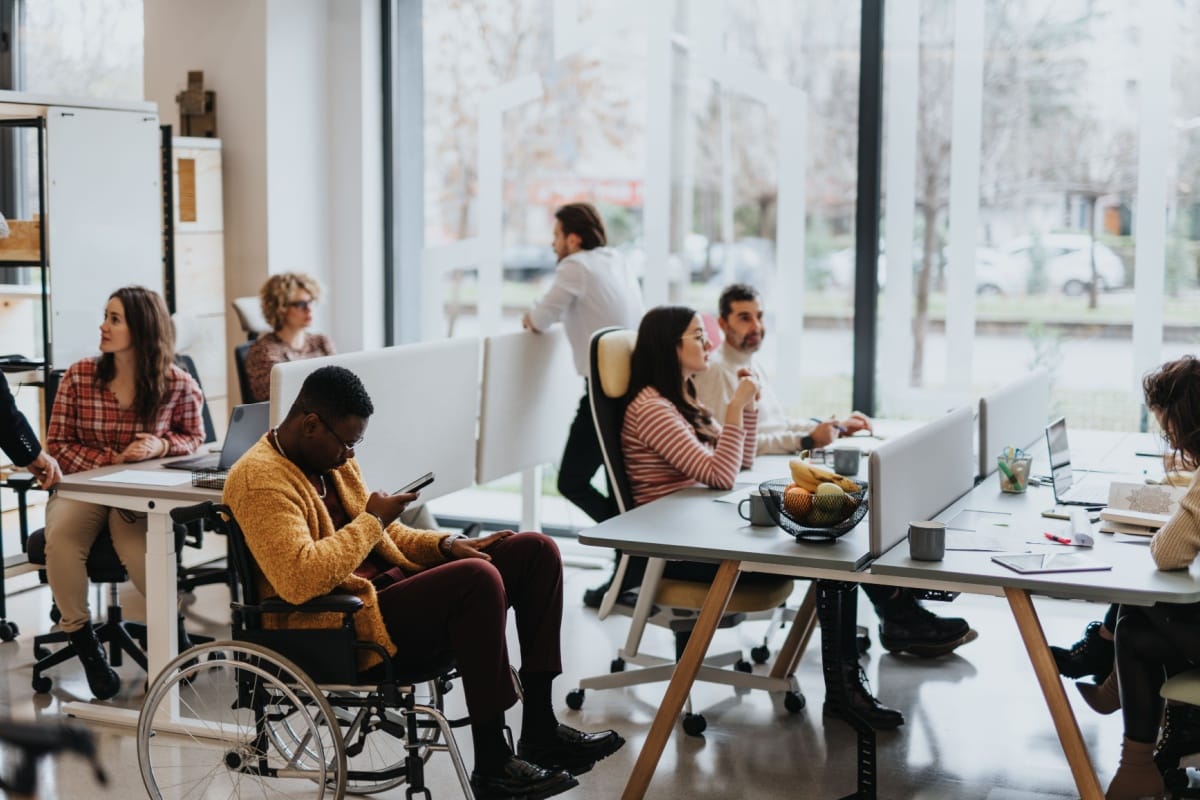 Modern coworking space in Marietta featuring a diverse team collaborating in a bright, flexible office environment, highlighting inclusivity, remote work culture, and productivity