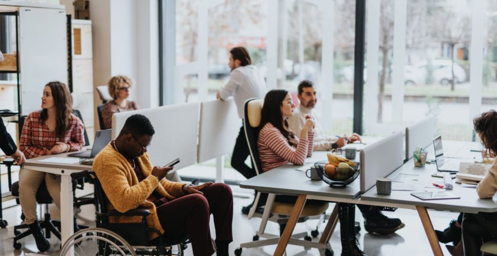 Modern coworking space in Marietta featuring a diverse team collaborating in a bright, flexible office environment, highlighting inclusivity, remote work culture, and productivity