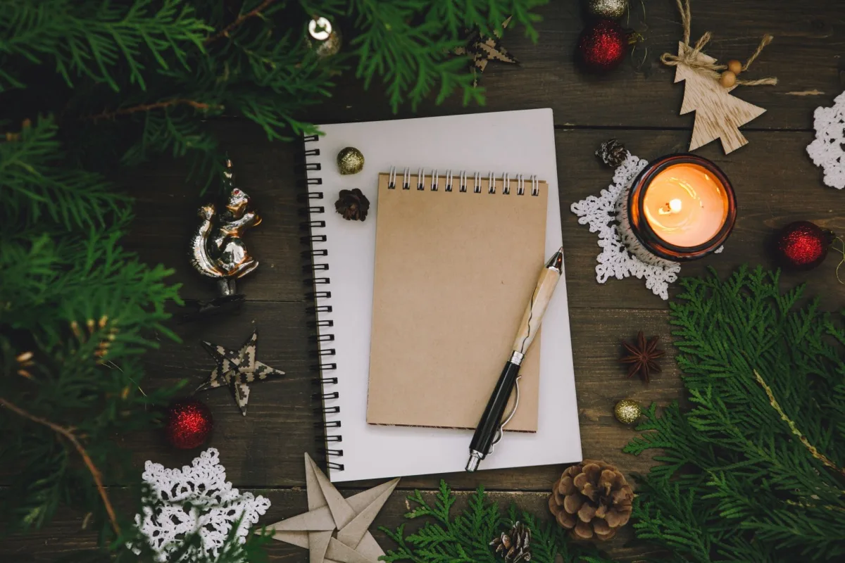 A notepad with holiday decor around